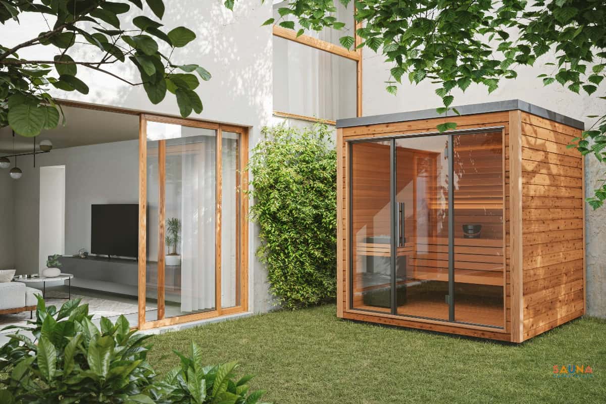 Auroom Mira L outdoor sauna beside a modern home and landscaped lawn